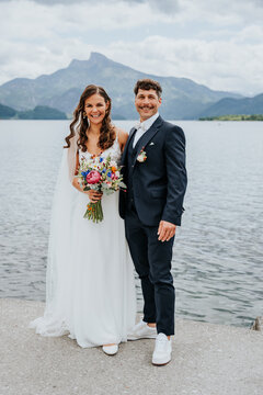 Bride and groom standing together at Lake Mondsee