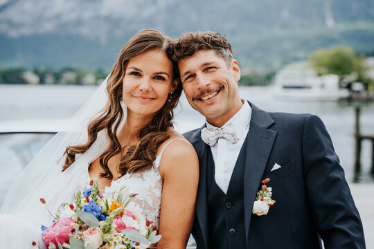 Smiling bride and groom portrait at Lake Mondsee