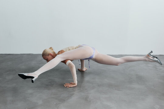 Woman balance on floor on hands