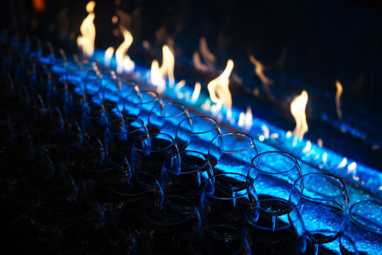 Wine Glasses Lined Up Beside Modern Fireplace
