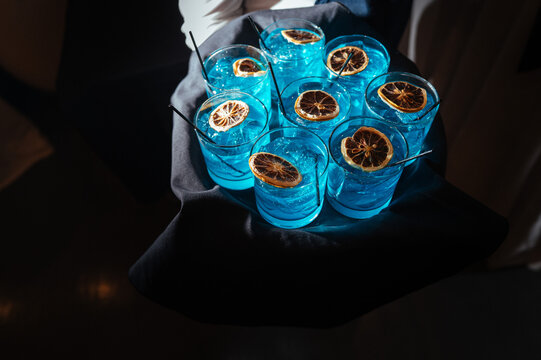 Blue Cocktails with Dried Citrus Garnish on Serving Tray
