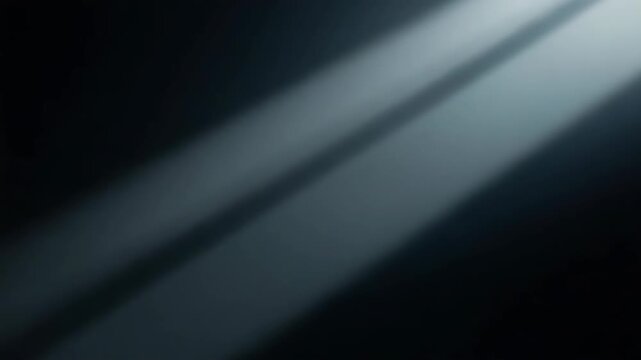 Soft diagonal light beams crossing dark metallic surface with cinematic reflection conveying moody