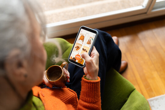 Senior woman shopping clothes online home