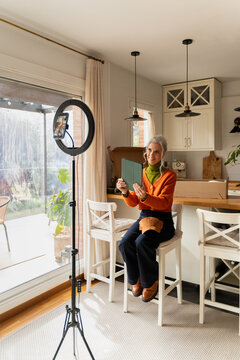 Senior woman recording video call at home