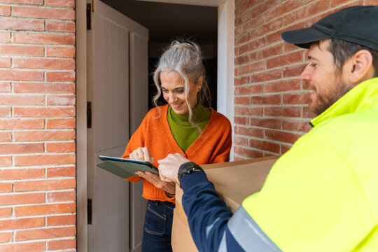 Senior woman signing delivery