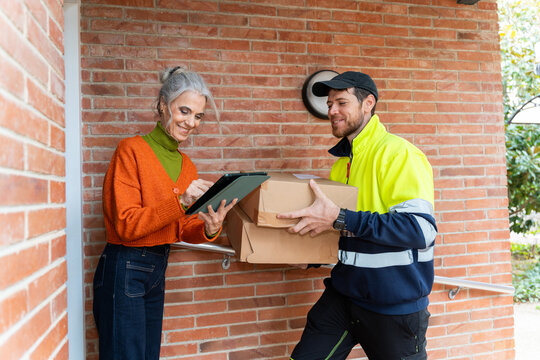 Senior woman signing delivery