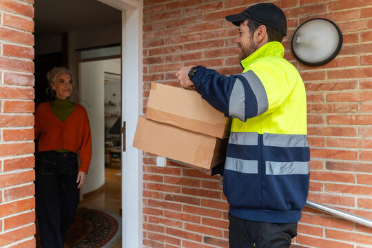 Courier delivering packages to senior woman
