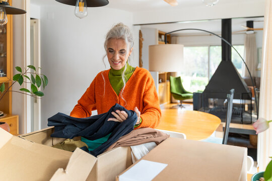 Senior WOMAN sorting new clothes