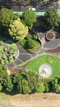 Ariel view of the lush green landscape and modern architecture of the Marine Parade, Napier, Hawkes Bay, New Zealand, showcasing its vibrant urban park.