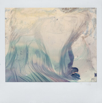 Abstract wavy textures on a damaged expired instant photo