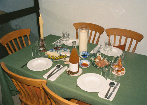A carefully arranged dinner table in a cozy indoor setting