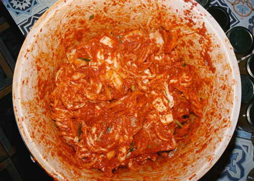 Plastic container filled with freshly prepared kimchi