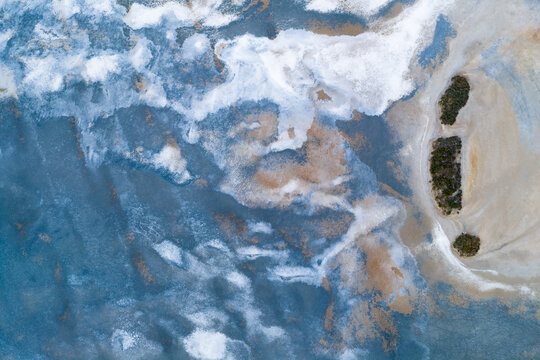 Abstract patterns and textures in a colorful drying salt lake