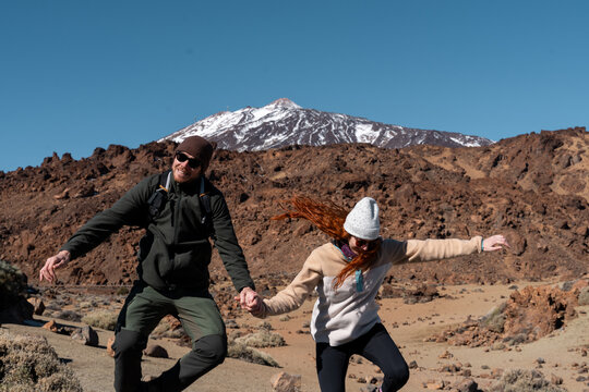 Couple jumping Teide volcano