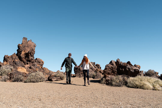 Couple walking volcanic landscape