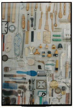 Close-up of old pegboard filled with tools and brushes
