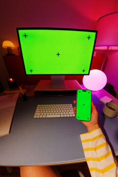 Phone mockup with computer green screen at home workspace
