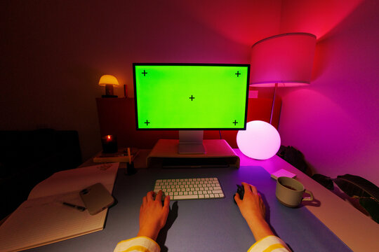 Desktop mockup with green screen in colorful workspace