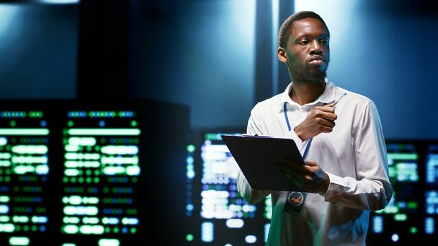 African american engineer preventing supercomputer cybersecurity issues arising due to unsecured network connections. Specialist making sure data center is invulnerable to phishing attacks