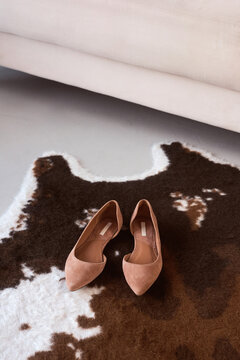 Stylish shoes placed on a textured rug in a modern interior