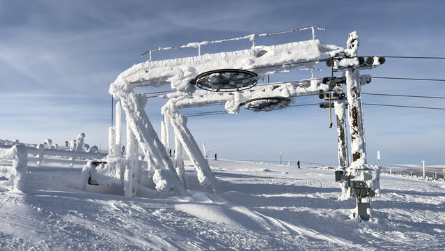 Frosted Ski Lift Tower on a Snowy Mountain Slope