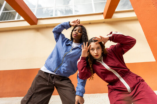 Two friends posing while dancing hiphop on the street