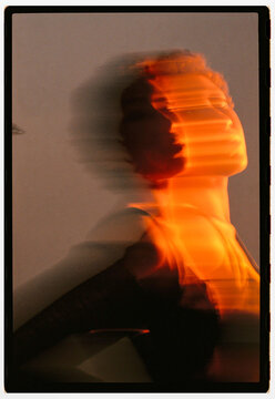 Figure in motion against a light background at an indoor setting
