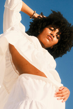 Confident black woman in white dress in Cape Town