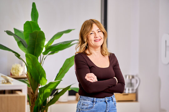 Woman smiling in beauty salon arms crossed