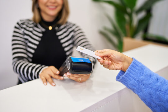 Client making contactless payment in beauty salon