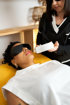 Client receiving laser hair removal treatment at beauty salon