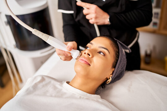 Woman receiving facial treatment in beauty salon
