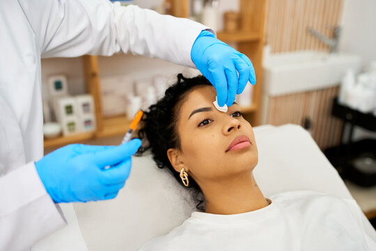 Woman receiving aesthetic injection treatment for facial skin care