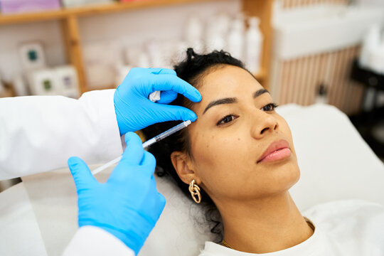 Woman receiving cosmetic injection for facial rejuvenation procedure