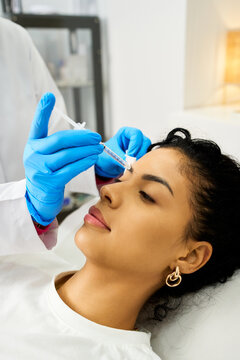 Woman receiving aesthetic injection for facial rejuvenation at clinic