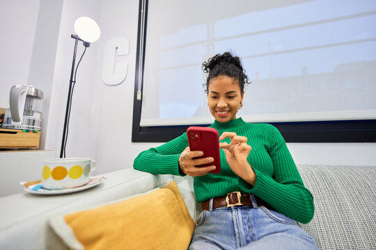 Woman relaxing at beauty salon using smartphone