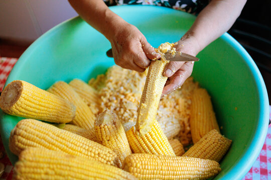 Unrecognizable Person Removing Corn Kernels