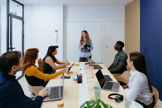 Businesswoman presenting during a diverse team meeting in office