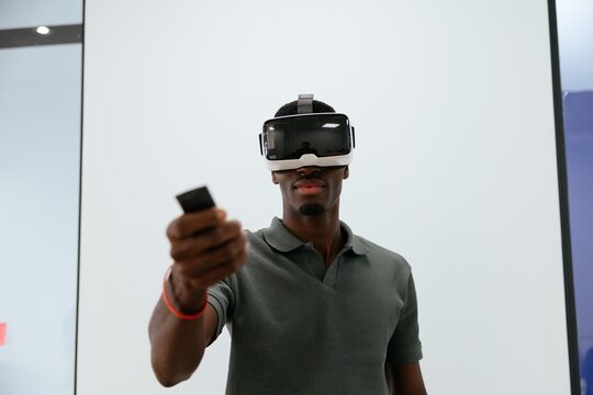 Man experiencing virtual reality using vr headset and controller