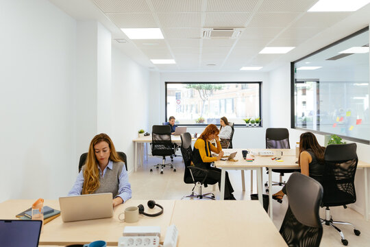 Diverse professionals working in modern coworking office