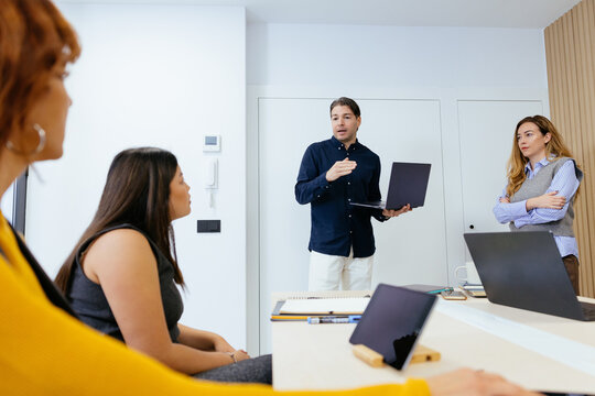 Business colleagues presenting ideas during a startup meeting