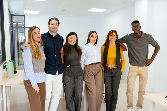 Diverse business team standing together in a modern office