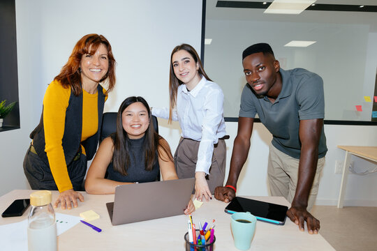 Diverse business team collaborating in modern office meeting
