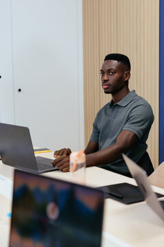 African american man working on laptop in modern office