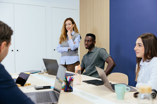 Business colleagues collaborating on project during office meeting
