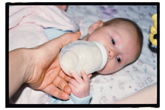 Baby feeding time with a bottle in a cozy room