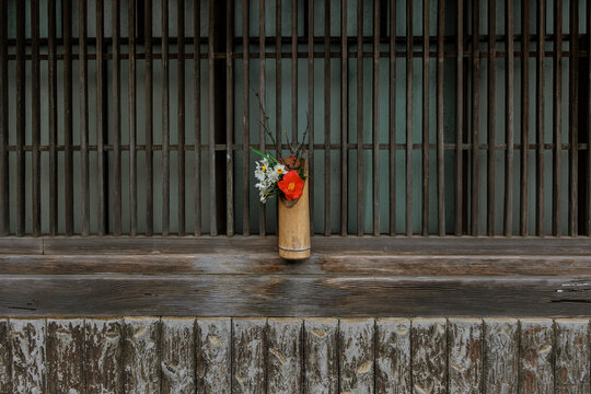 Seasonal Ikebana Before a Traditional Japanese Lattice Window.
