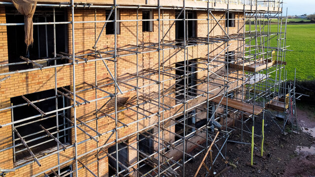 Aerial view of scaffolding around a new house in the countryside