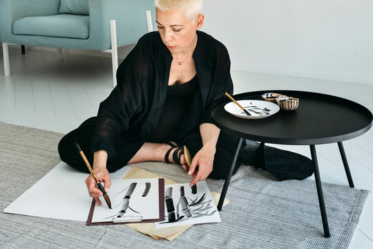 Creative Artist Immersed in Brush Strokes on a Tranquil Afternoon