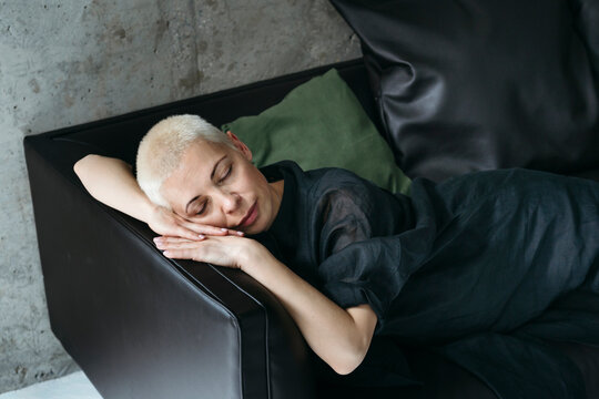 Peaceful Moment of Rest on a Cozy Black Couch